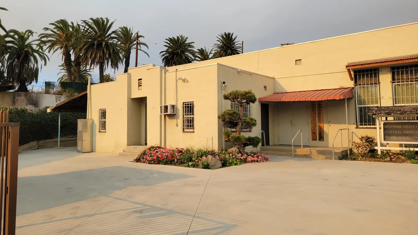 Exterior of the Hollywood Japanese Cultural Institute on Middlebury Street, with its entrance, landscaped courtyard, and palm trees.