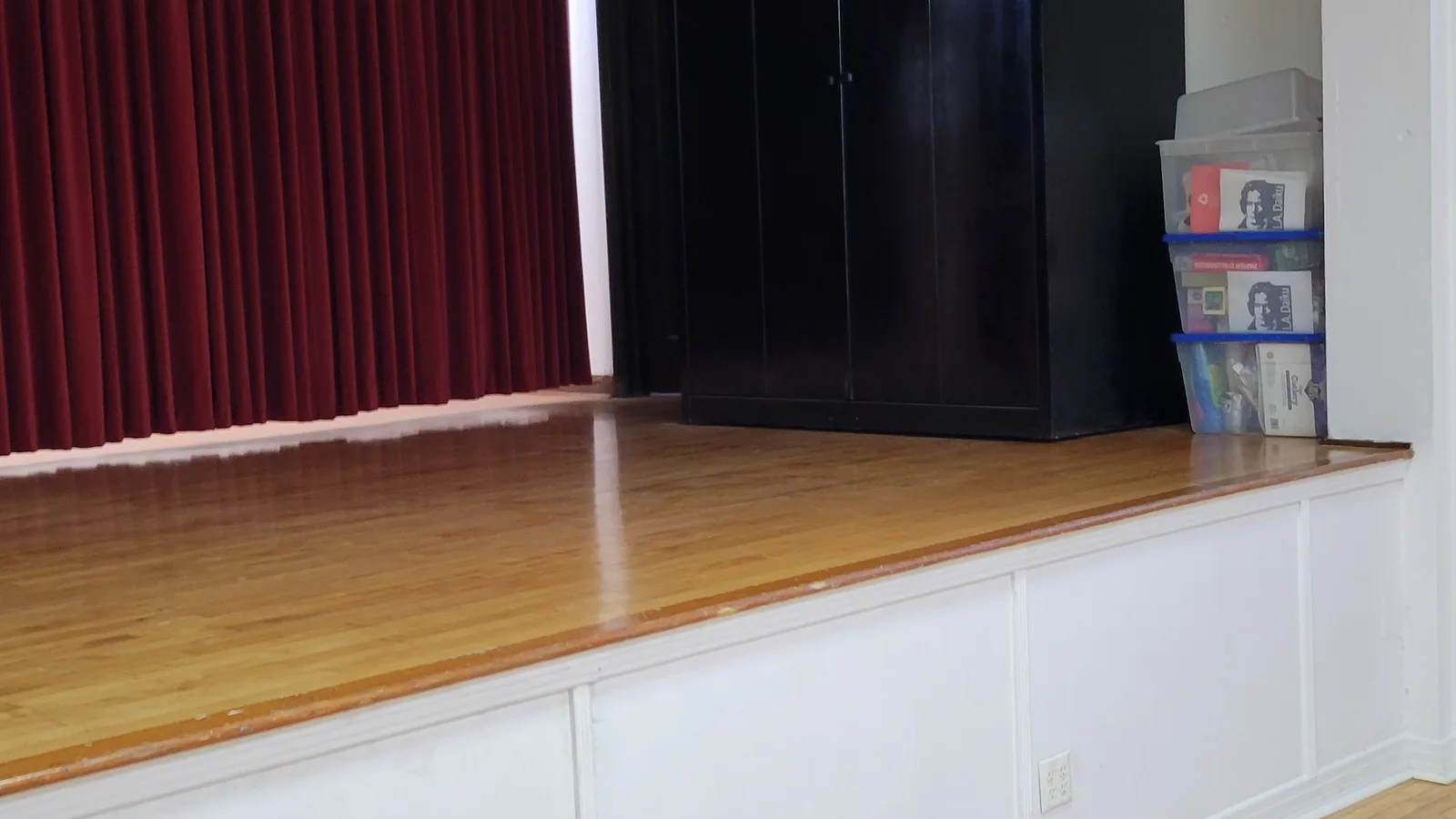 The stage and red curtain inside the HJCI multipurpose hall.