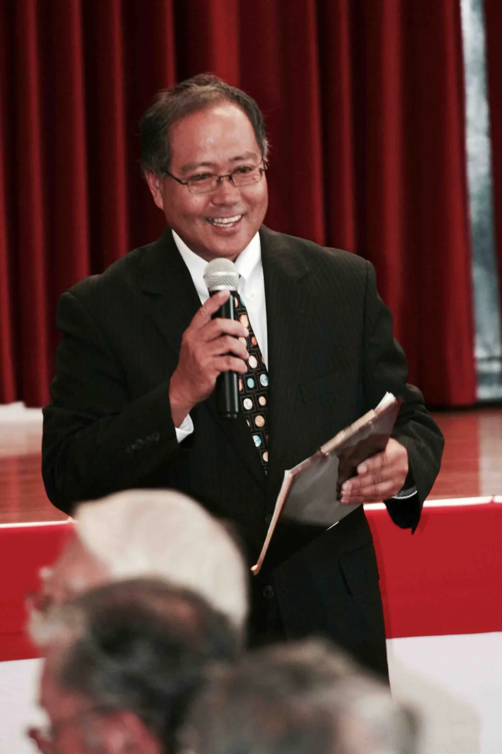 A speaker addressing a gathering in the HJCI Social Hall.